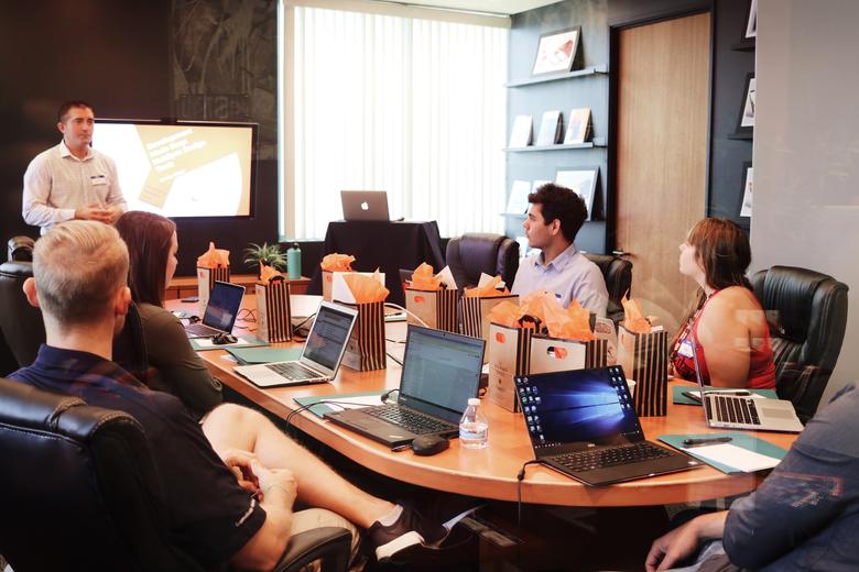 People in a meeting room around table