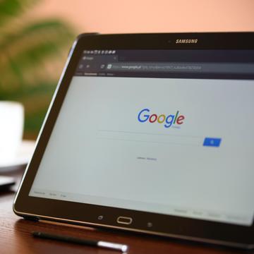Tablet on table displaying Google search page 